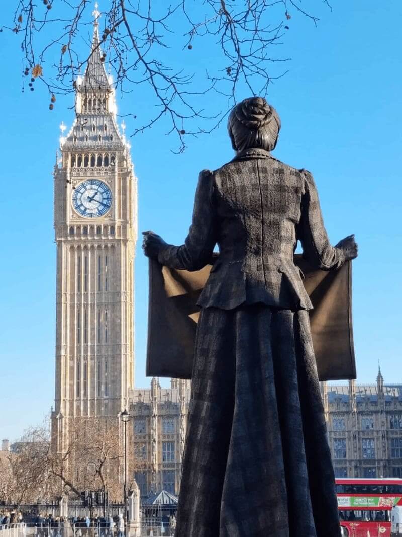 a statue of Millicent Fawcett from the back